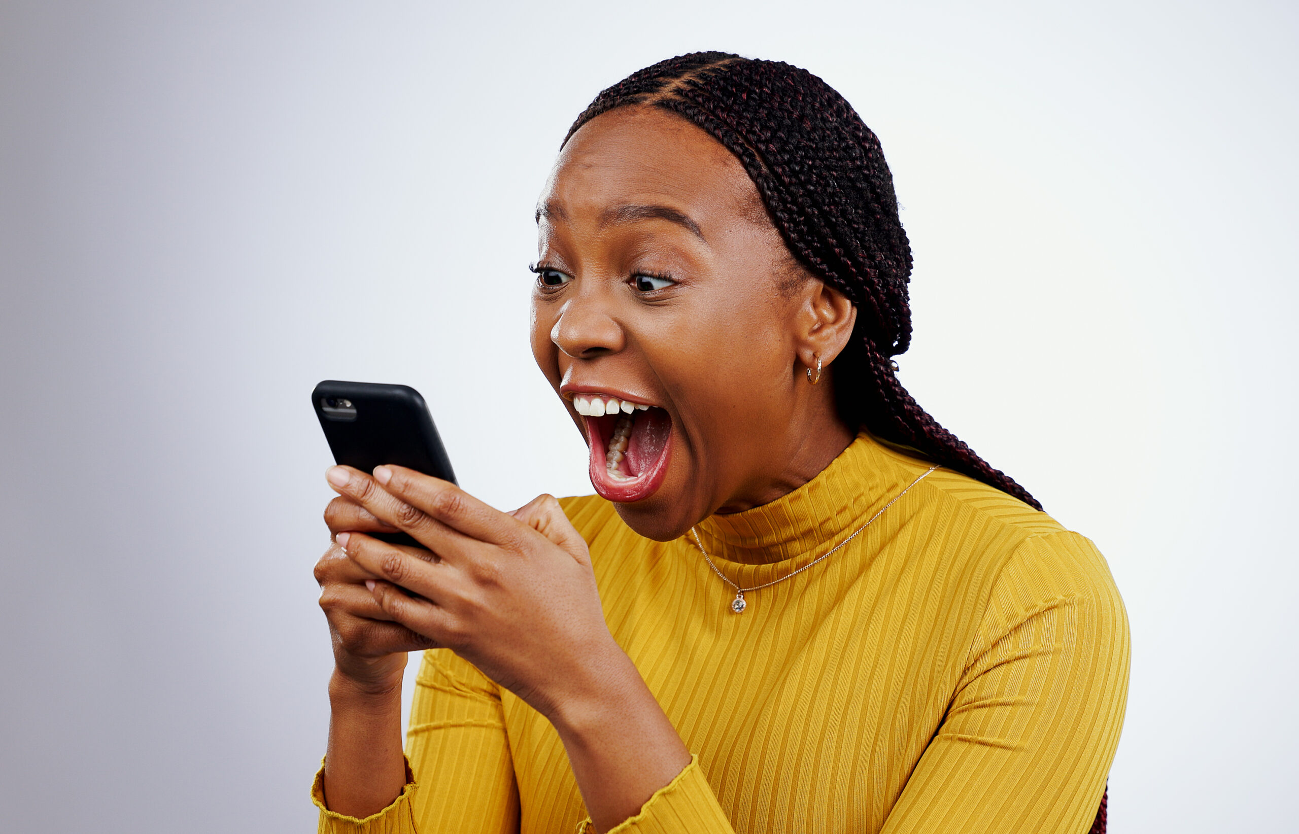 Woman, reading phone and wow for happy news, social media competition or giveaway success on a white background. African person with surprise, excited and shocked for mobile sale or bonus in studio