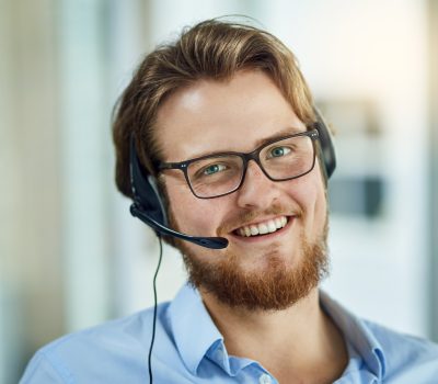 Portrait of a young call centre agent working in an office