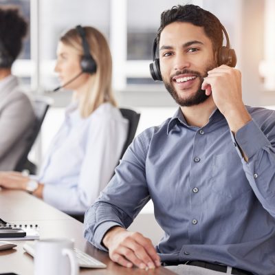 Portrait, call center and customer service with a man consulting using a headset in his support office. CRM, contact us or telemarketing with a male consultant working  in an agency for communication