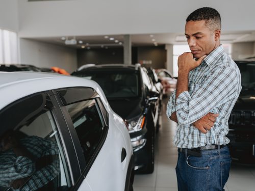 Man analyzing car to buy