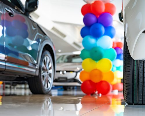 Car parked in luxury showroom. Car dealership office. Car showroom business. New car parked in modern showroom. Auto for sale and rent business. Automobile leasing and insurance. Electric automobile.